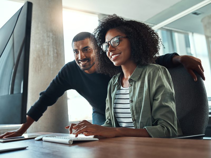 Two professional business people working together in office